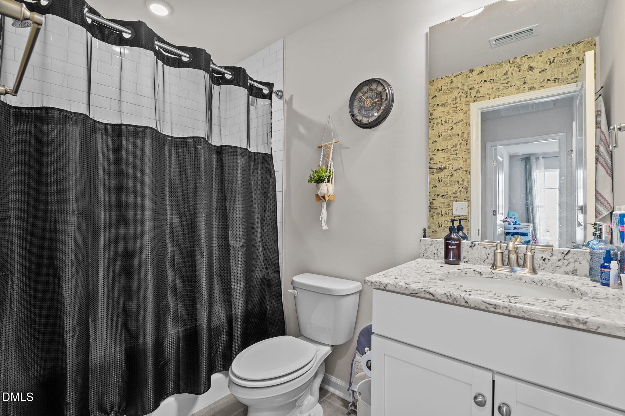 1572 Rhodes Pond Street Wendell, NC 27591 - Photo 36 of 42 a bathroom with a granite countertop sink toilet and a mirror