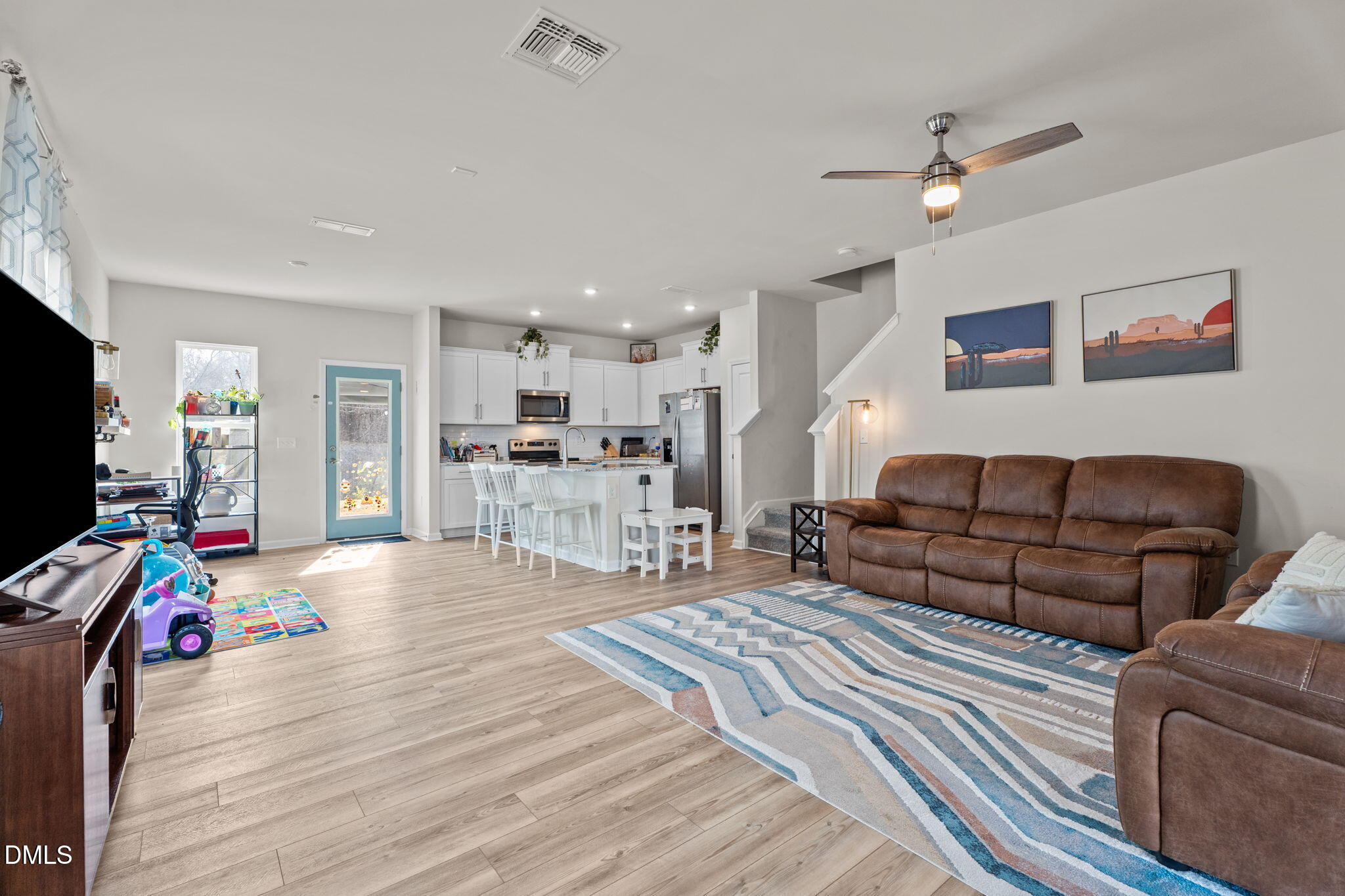 1572 Rhodes Pond Street Wendell, NC 27591 - Photo 7 of 42 a living room with furniture and a flat screen tv