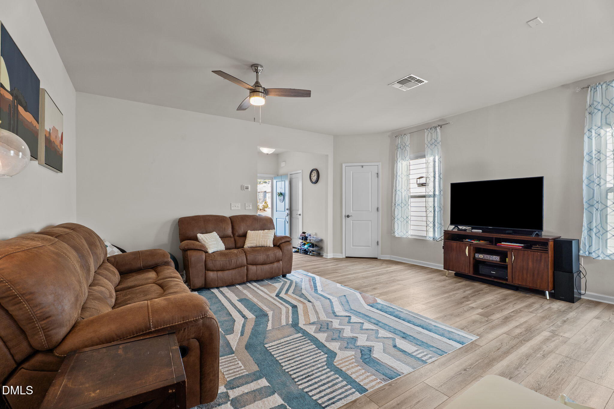 1572 Rhodes Pond Street Wendell, NC 27591 - Photo 10 of 42 a living room with furniture and a flat screen tv
