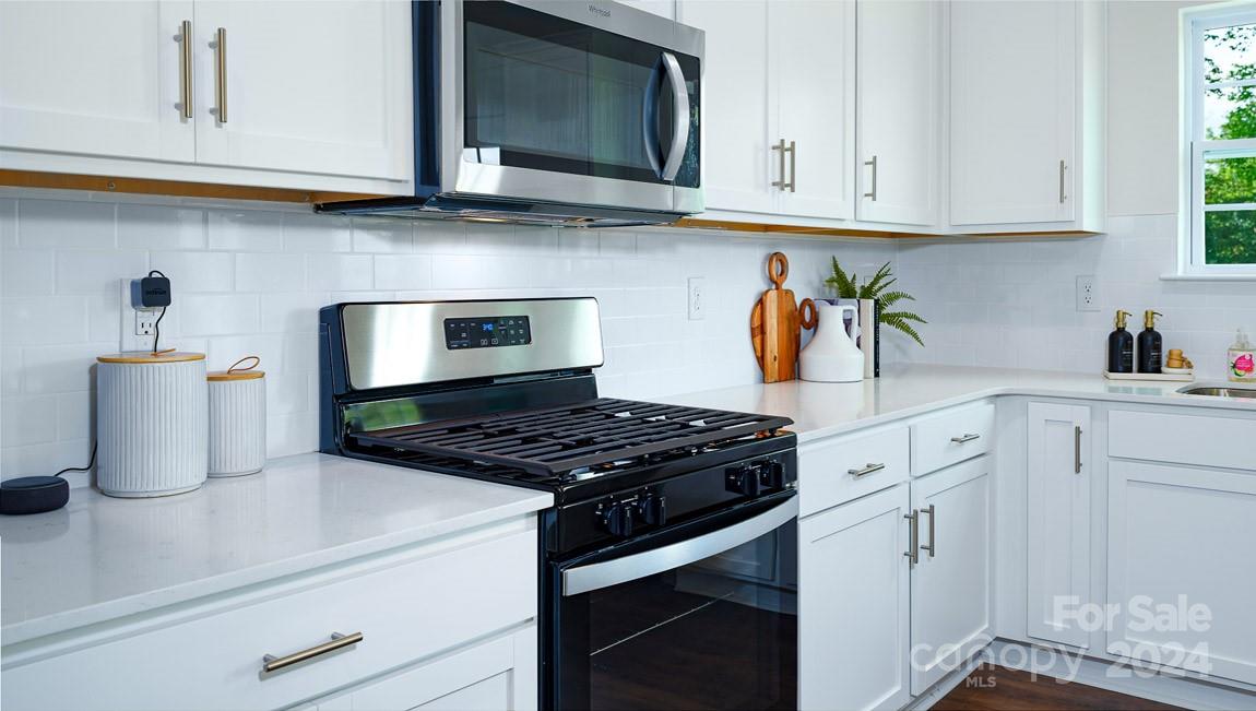 186 Wheatfield Road Fletcher, NC 28732 - Photo 6 of 25 a kitchen with stainless steel appliances granite countertop a sink and a stove