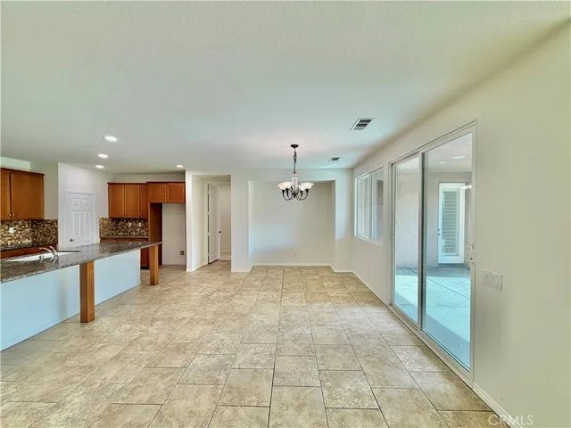 a view of a kitchen with a sink and a refrigerator