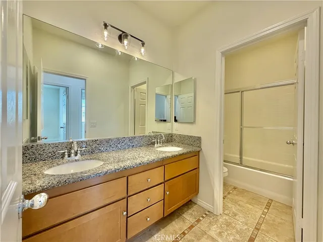 a bathroom with a granite countertop sink a mirror and a