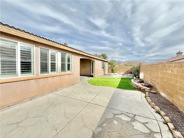 a view of house with backyard and glass windows