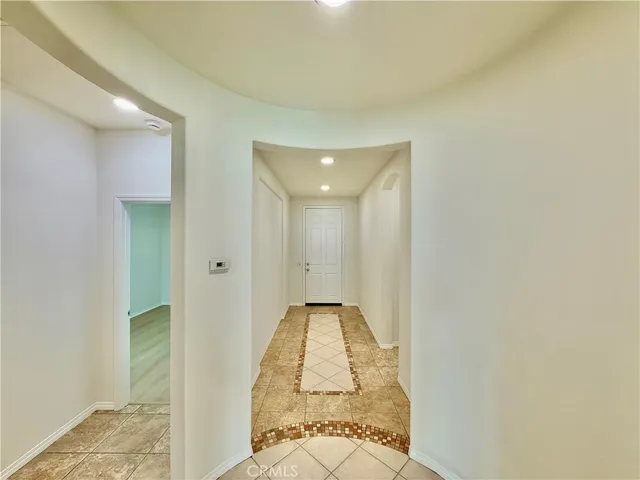 a view of a bathroom with mirror and shower