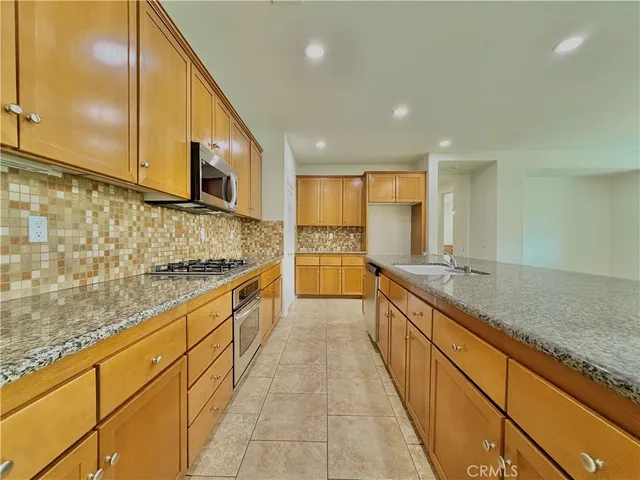 a large kitchen with kitchen island granite countertop a large counter top and sink