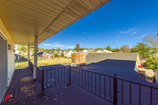 a view of a balcony with chair and table