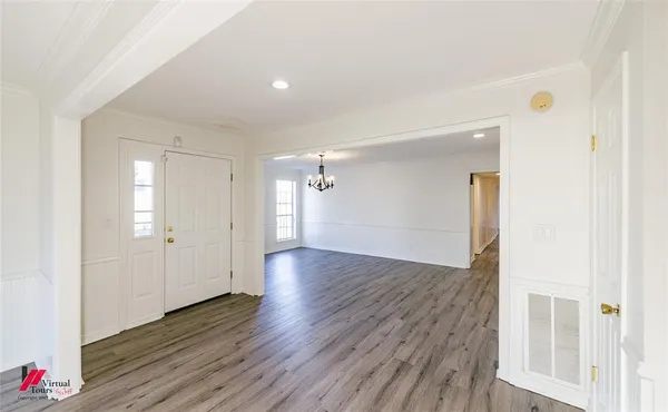 a view of a hallway with wooden floor