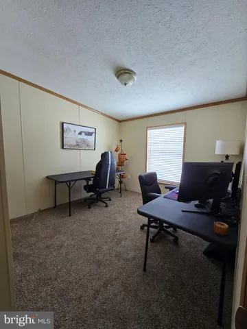 a bathroom with a granite countertop toilet sink and mirror