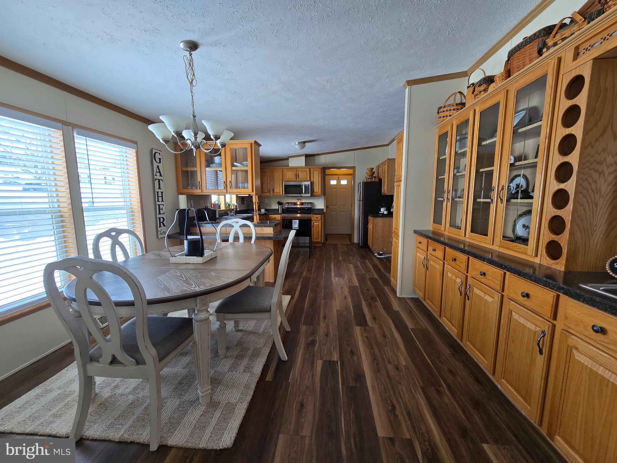 118 Lisa Circle York, PA 17406 - Photo 5 of 12 a view of a dining room and livingroom with furniture wooden floor a chandelier