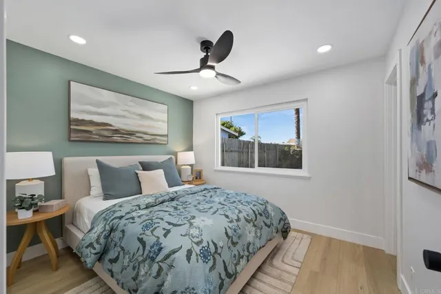 a bedroom with a bed and a painting on the wall