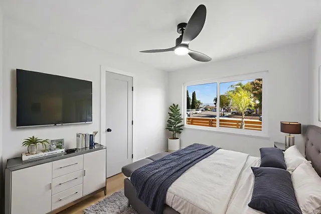 a bedroom with a bed and a flat screen tv