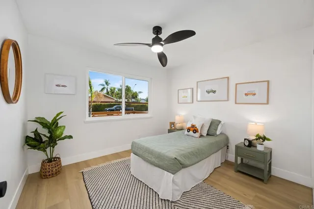 a bedroom with a bed and a potted plant