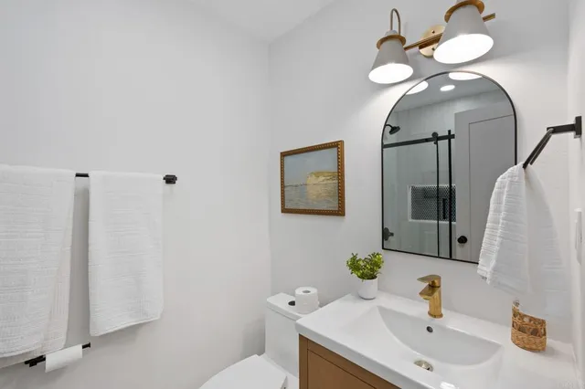 a bathroom with a toilet sink and mirror