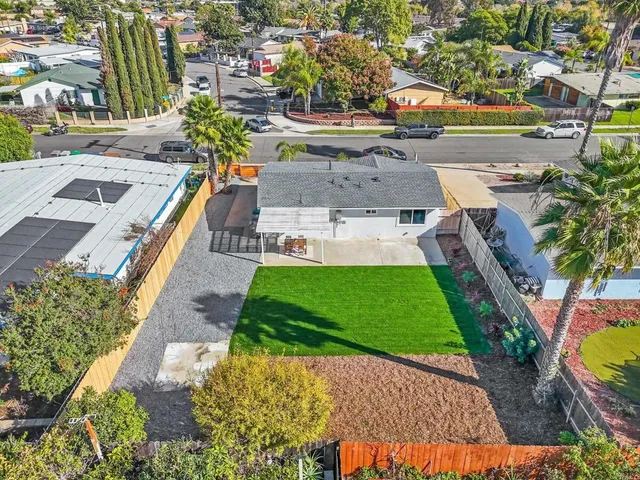 an aerial view of a house with a garden and swimming pool