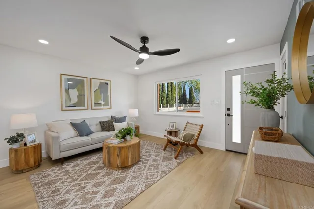 a living room with furniture and wooden floor