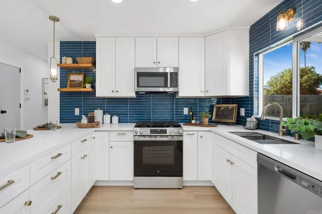 a kitchen with cabinets stainless steel appliances and a sink