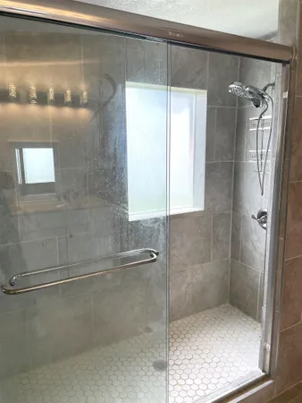 a bathroom with a glass shower door