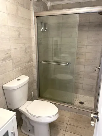 a bathroom with a toilet and a shower