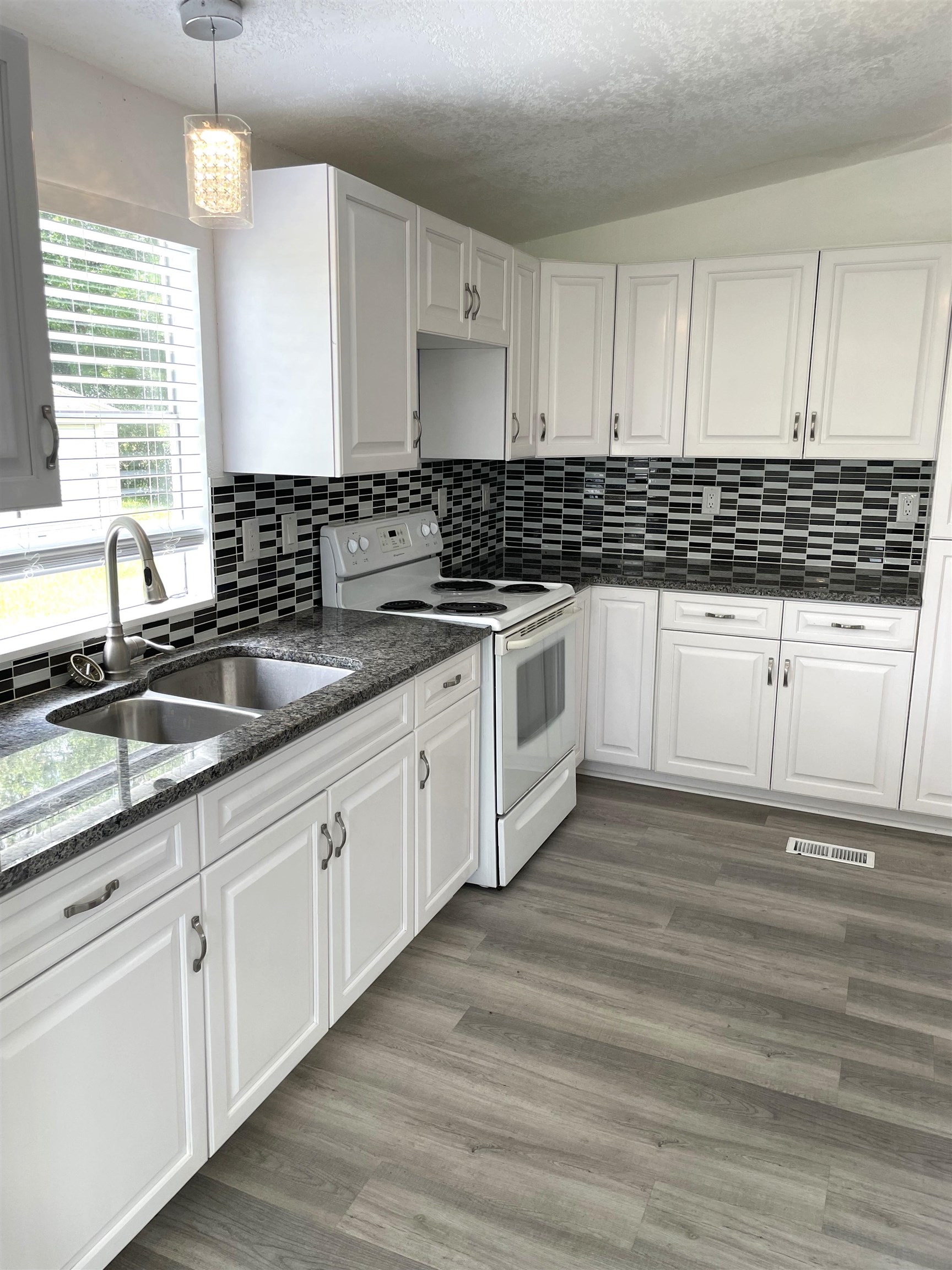 3125 Audra Road St. Augustine, FL 32084 - Photo 2 of 15 a kitchen with granite countertop white cabinets white stainless steel appliances with a sink and dishwasher