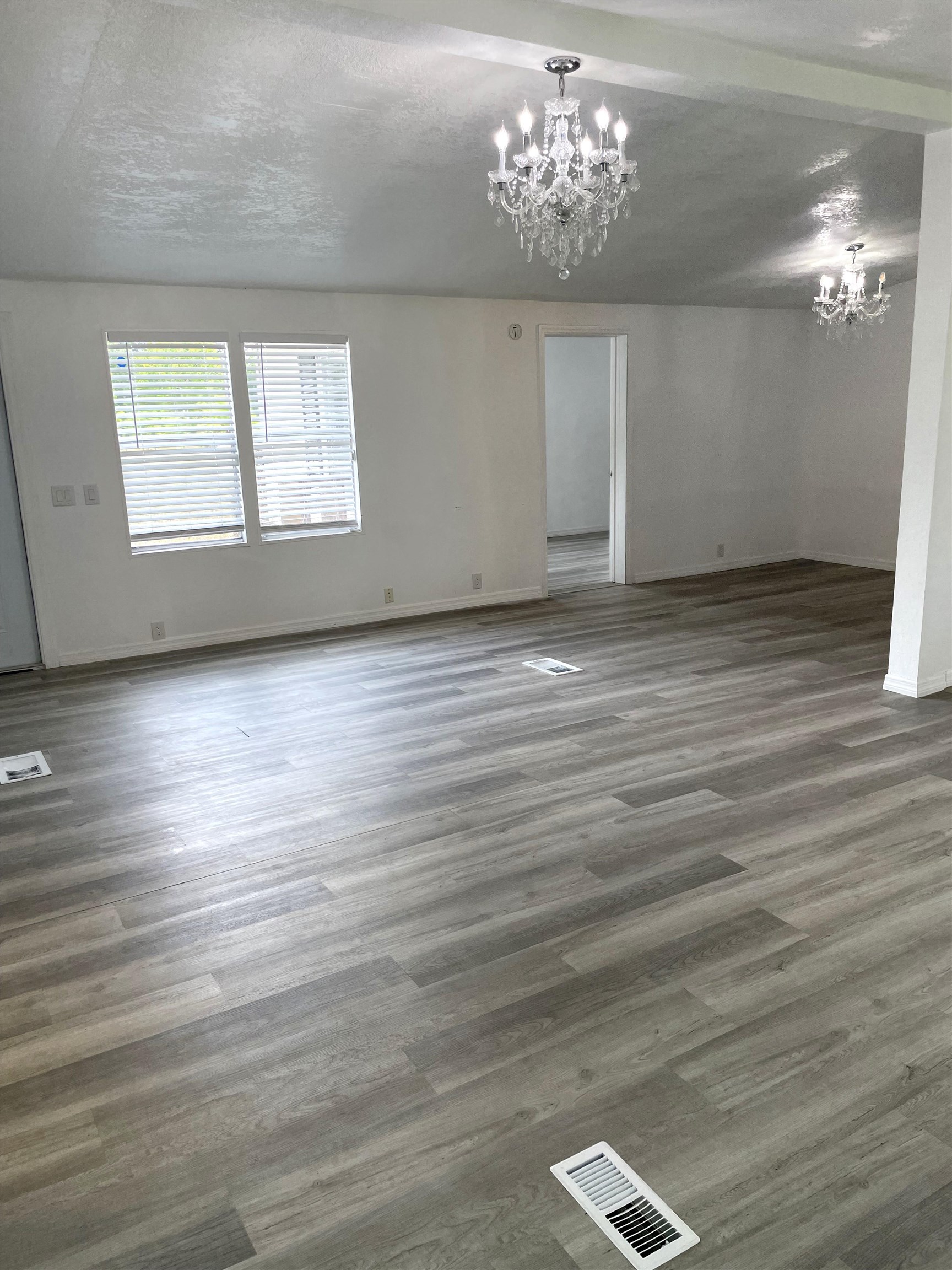 3125 Audra Road St. Augustine, FL 32084 - Photo 4 of 15 an empty room with wooden floor chandelier and windows
