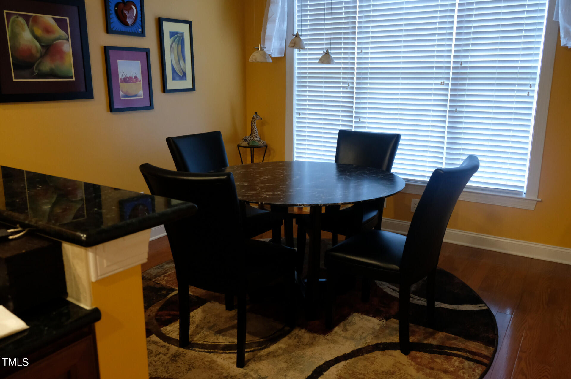 9545 Brookchase Drive Raleigh, NC 27617 - Photo 11 of 46 a view of a dining room with furniture and wooden floor