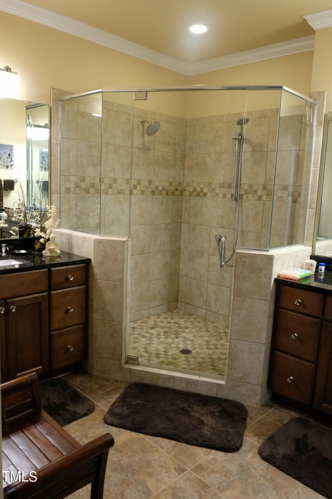 9545 Brookchase Drive Raleigh, NC 27617 - Photo 17 of 46 a bathroom with a shower a mirror and a sink