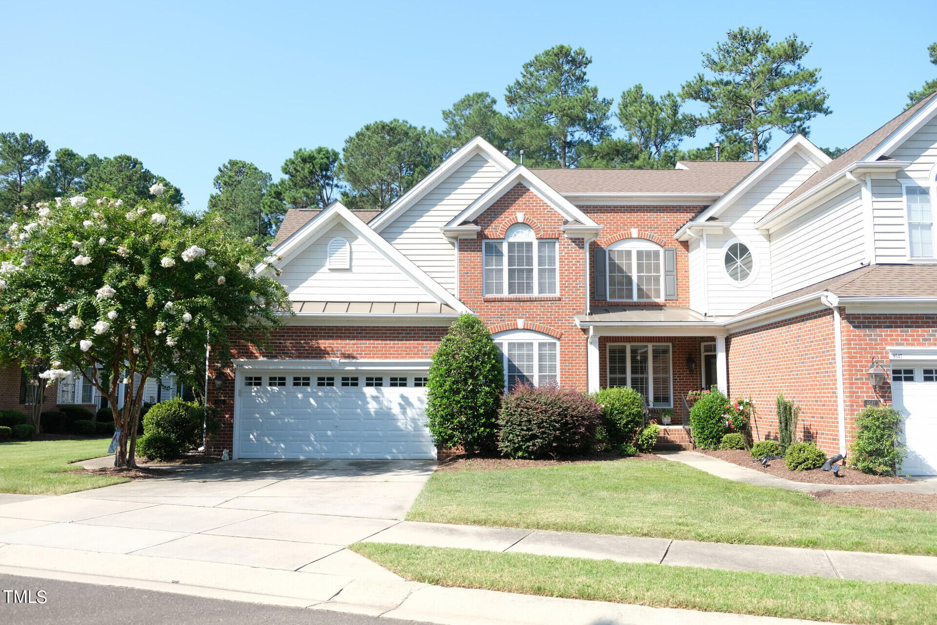 9545 Brookchase Drive Raleigh, NC 27617 - Photo 2 of 46 a front view of a house with a yard and a garage