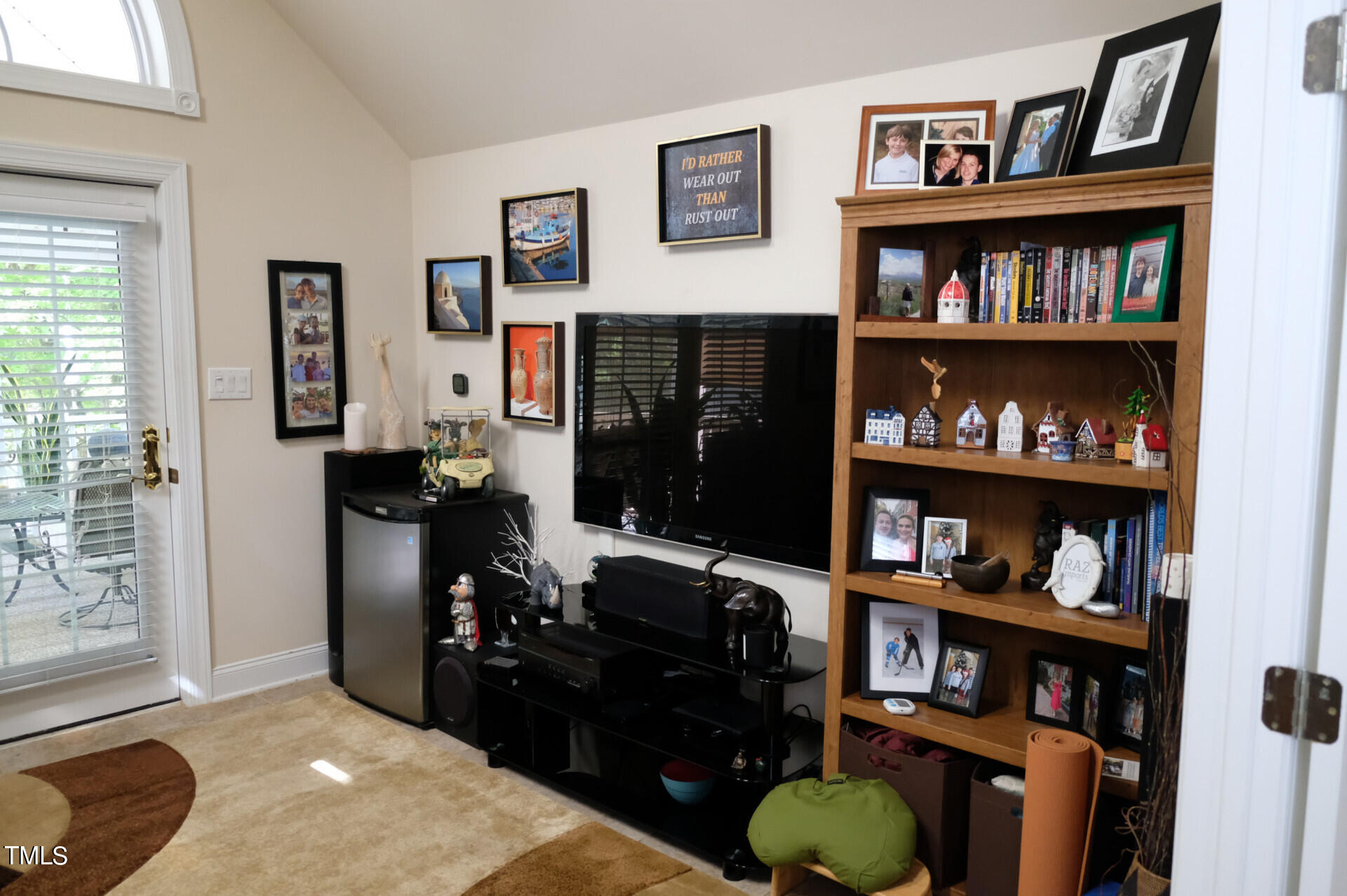 9545 Brookchase Drive Raleigh, NC 27617 - Photo 21 of 46 a living room with lots of books and a bookshelf