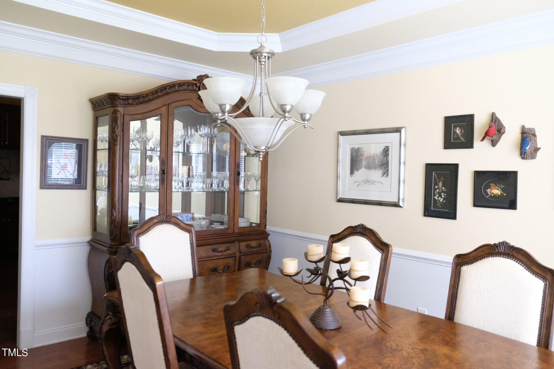 9545 Brookchase Drive Raleigh, NC 27617 - Photo 25 of 46 a view of a dining room with furniture a chandelier and wooden floor