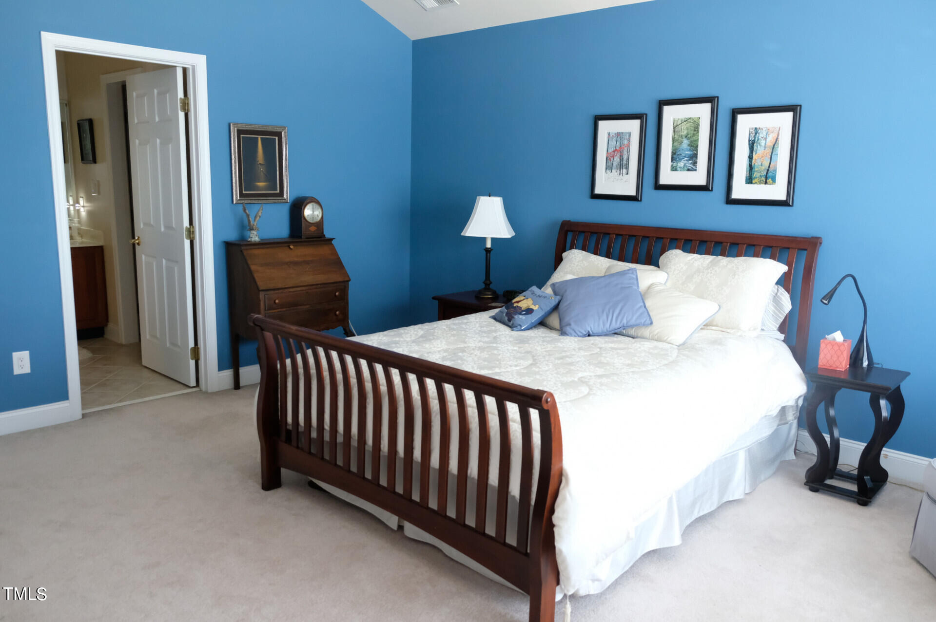 9545 Brookchase Drive Raleigh, NC 27617 - Photo 31 of 46 a bedroom with a bed and a chandelier