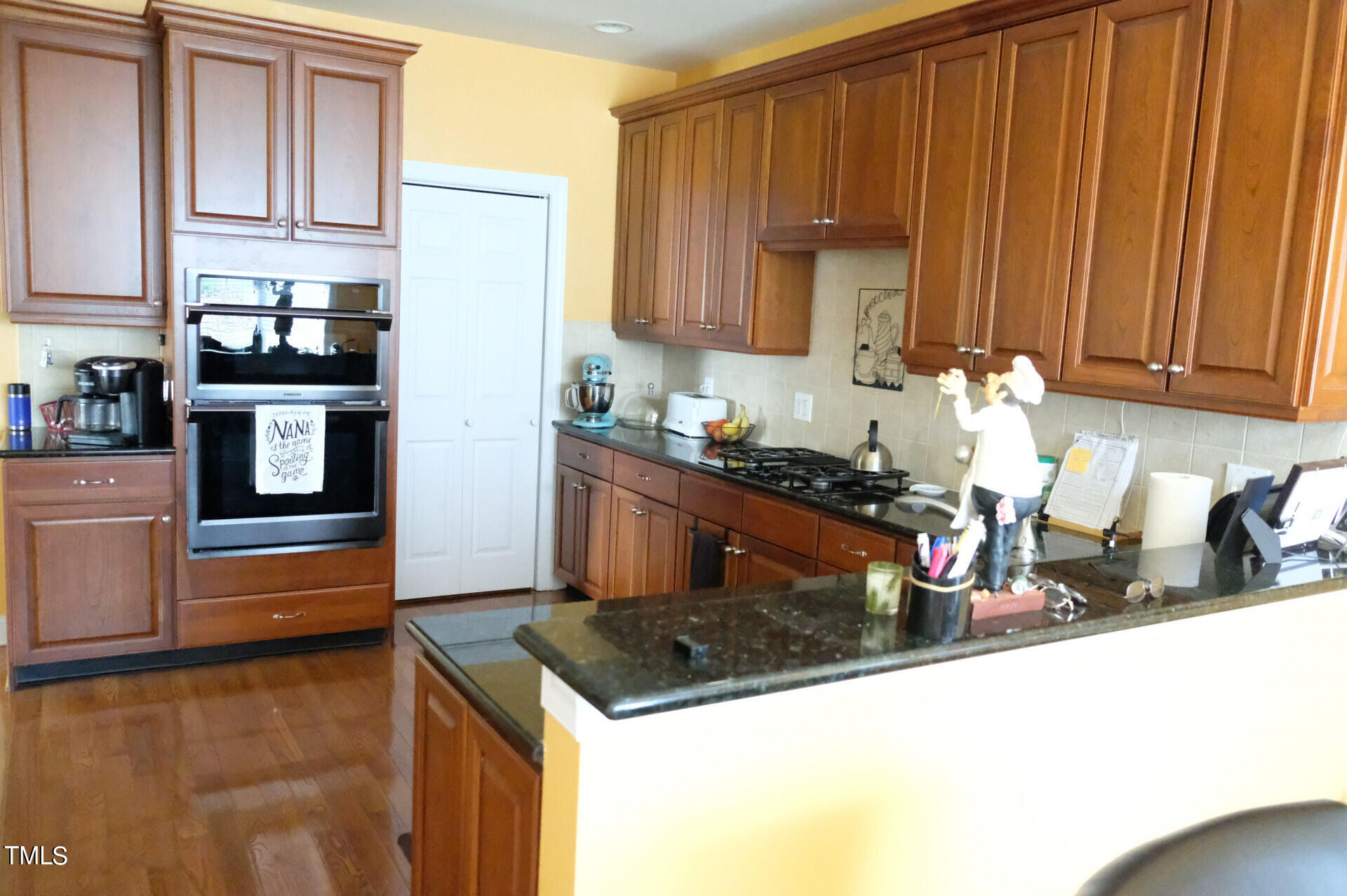 9545 Brookchase Drive Raleigh, NC 27617 - Photo 8 of 46 a kitchen with stainless steel appliances granite countertop a sink stove and cabinets