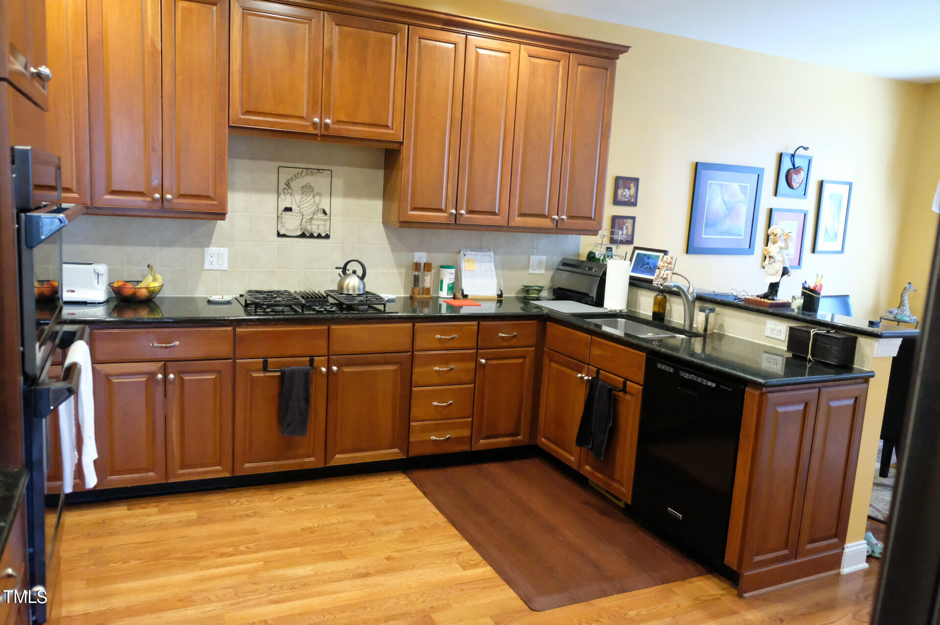 9545 Brookchase Drive Raleigh, NC 27617 - Photo 9 of 46 a kitchen with stainless steel appliances granite countertop a sink stove and cabinets
