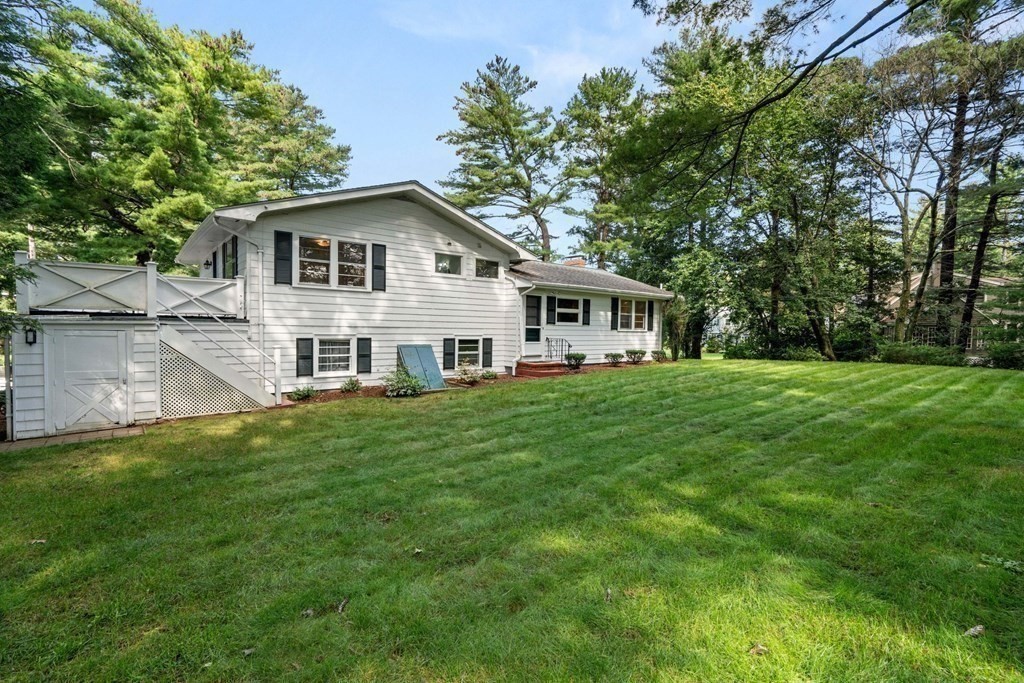 136 Phillips Brooks Road Westwood, MA 02090 - Photo 4 of 8 a white house that has a big yard with wooden fence