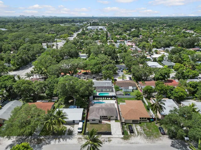 an aerial view of a house with a yard