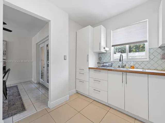 a kitchen with granite countertop cabinets and window