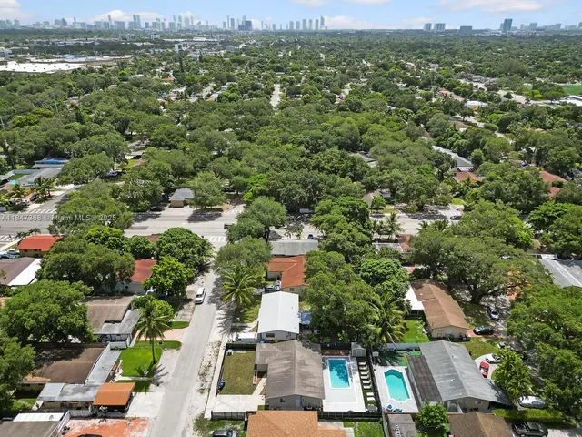 an aerial view of residential houses with outdoor space and river view