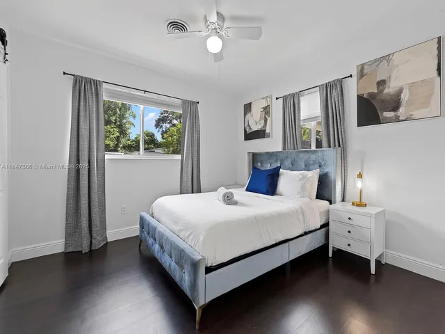 a large bed sitting in a bedroom next to a window