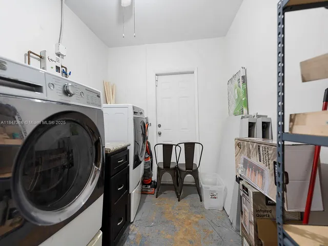 a view of a storage and utility room with washer and dryer