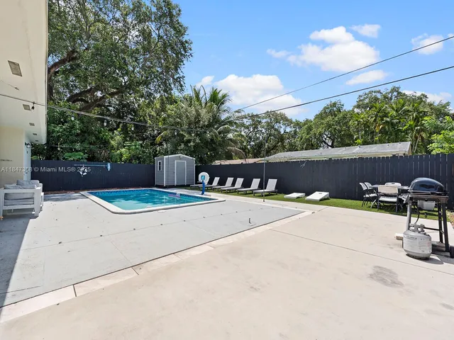 a view of a backyard with sitting area