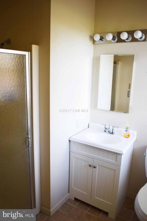 13285 Renshaw Road Princess Anne, MD 21853 - Photo 22 of 37 a bathroom with a sink and a mirror