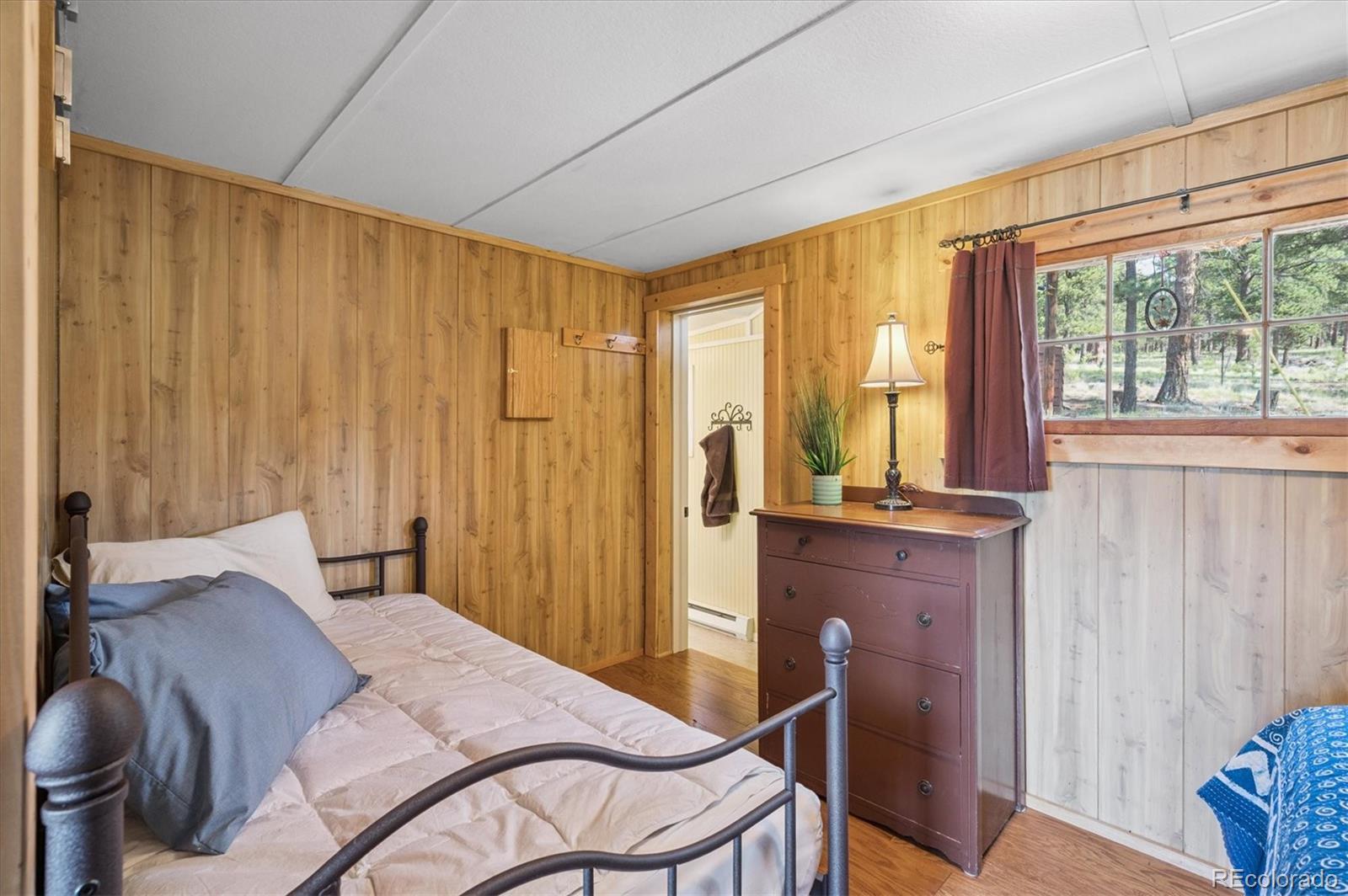 990 Rd P69 Bailey, CO 80421 - Photo 11 of 17 a bedroom with a bed and a window