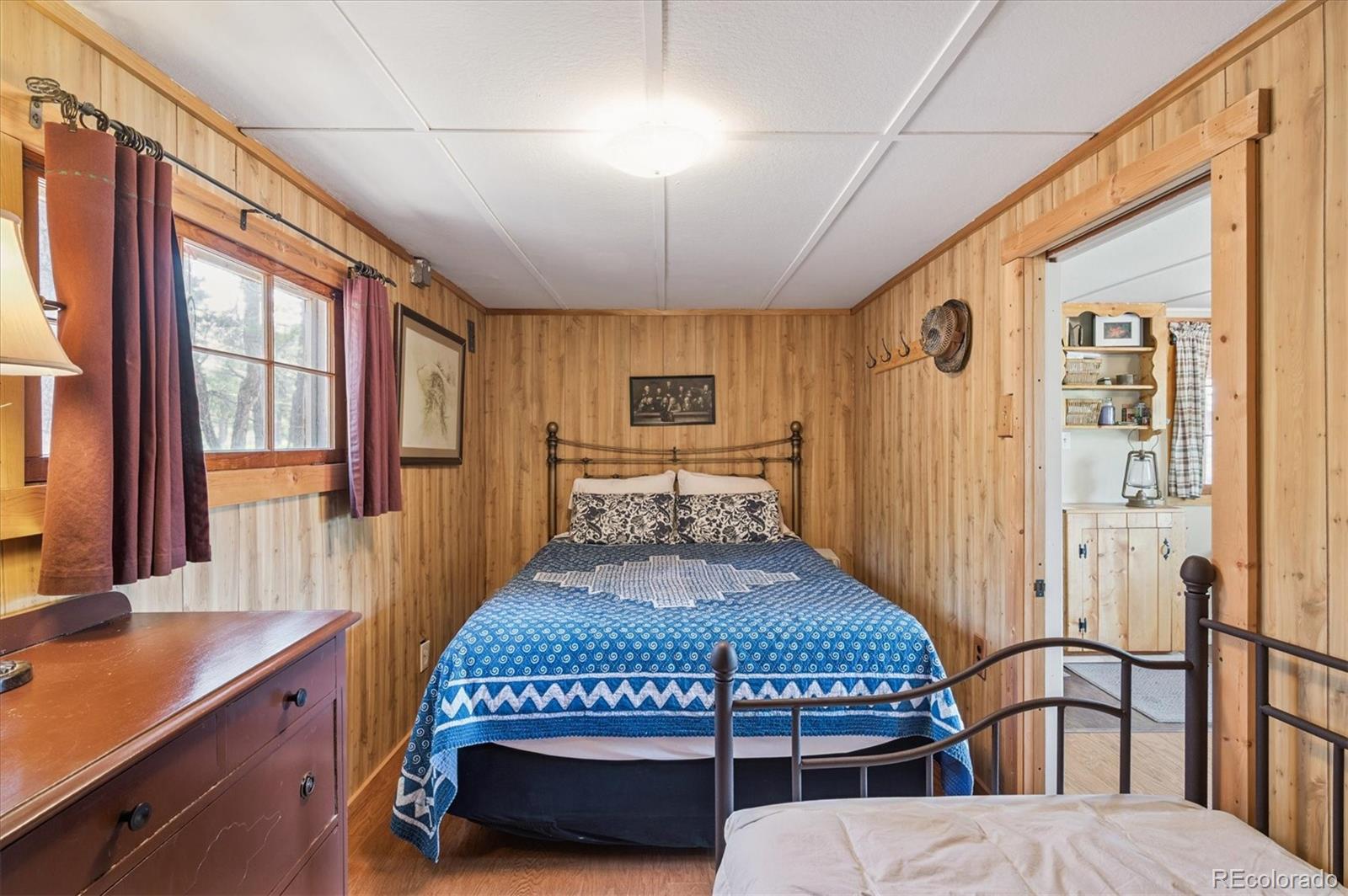 990 Rd P69 Bailey, CO 80421 - Photo 12 of 17 a bedroom with a bed next to a window with outer view