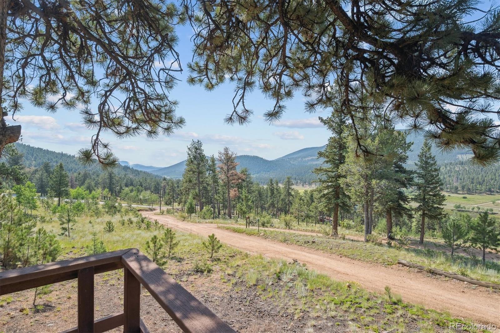 990 Rd P69 Bailey, CO 80421 - Photo 2 of 17 a view of a yard with wooden fence