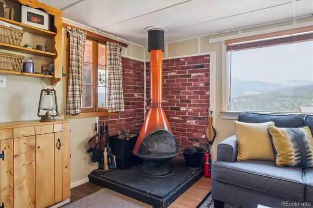 a living room with furniture a flat screen tv and a window