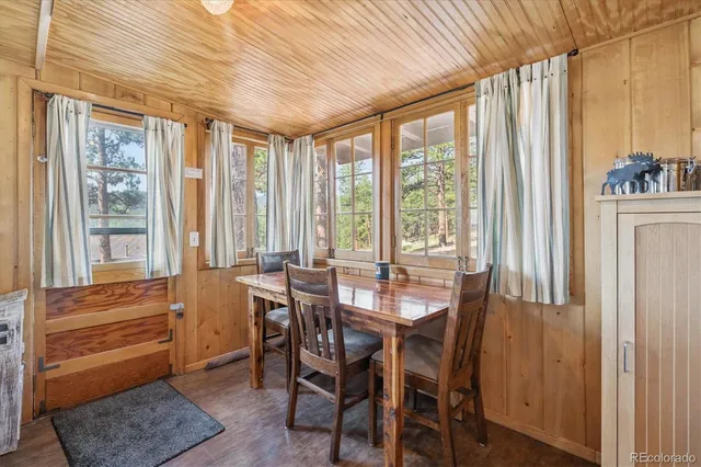 a view of a dining room with furniture and large window