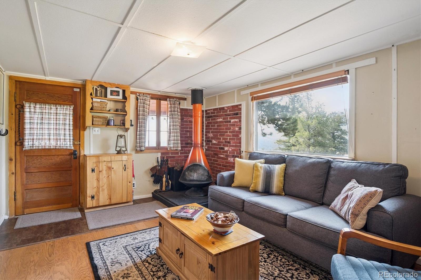 990 Rd P69 Bailey, CO 80421 - Photo 6 of 17 a living room with furniture and a large window