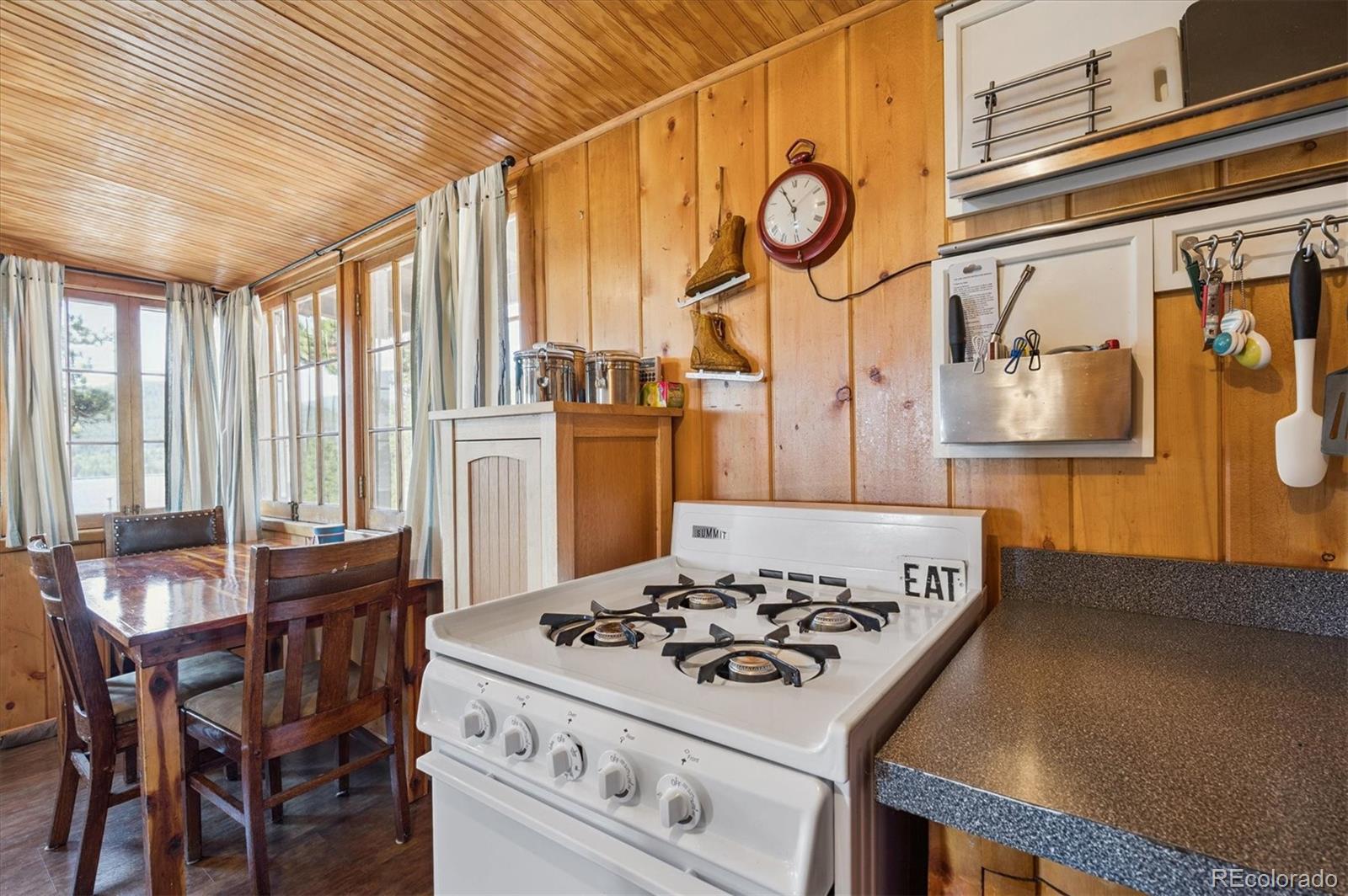 990 Rd P69 Bailey, CO 80421 - Photo 10 of 17 a kitchen with a stove and a table
