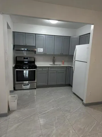 a kitchen with a sink and a refrigerator
