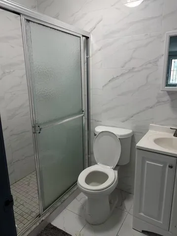 a bathroom with a toilet and a shower