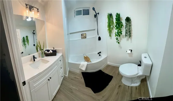 a spacious bathroom with a toilet sink and mirror